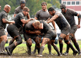 photo of men tackling in a game of rugby