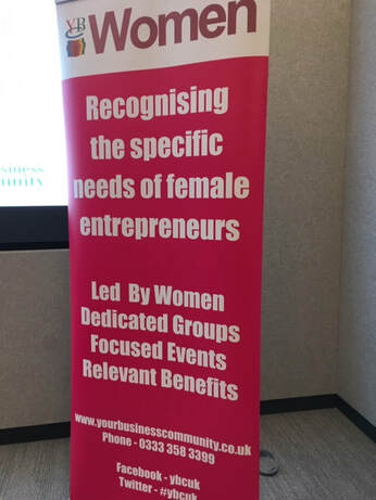 a pop up banner advertising the womens conference for Your Business Community event
