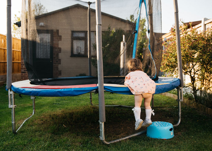 Project 365 - girl trying to get on trampoline by Alina Clark Photography