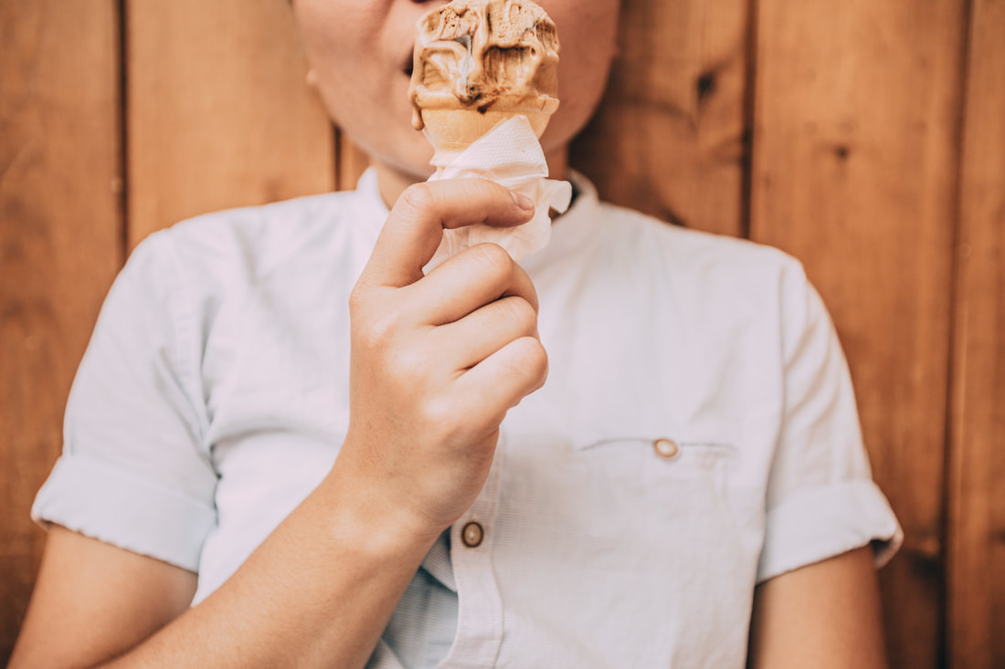 Photo of boy eating a chocolate ice cream