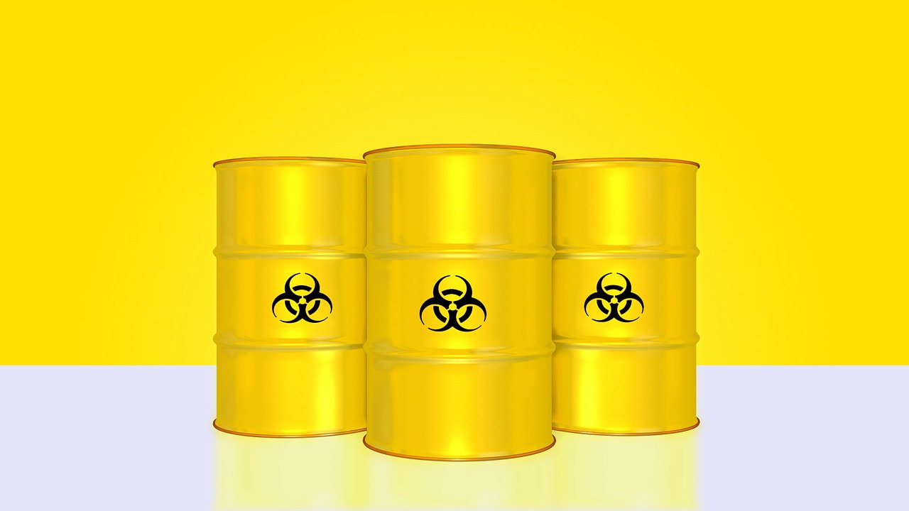 Three yellow barrels with a toxic image on them