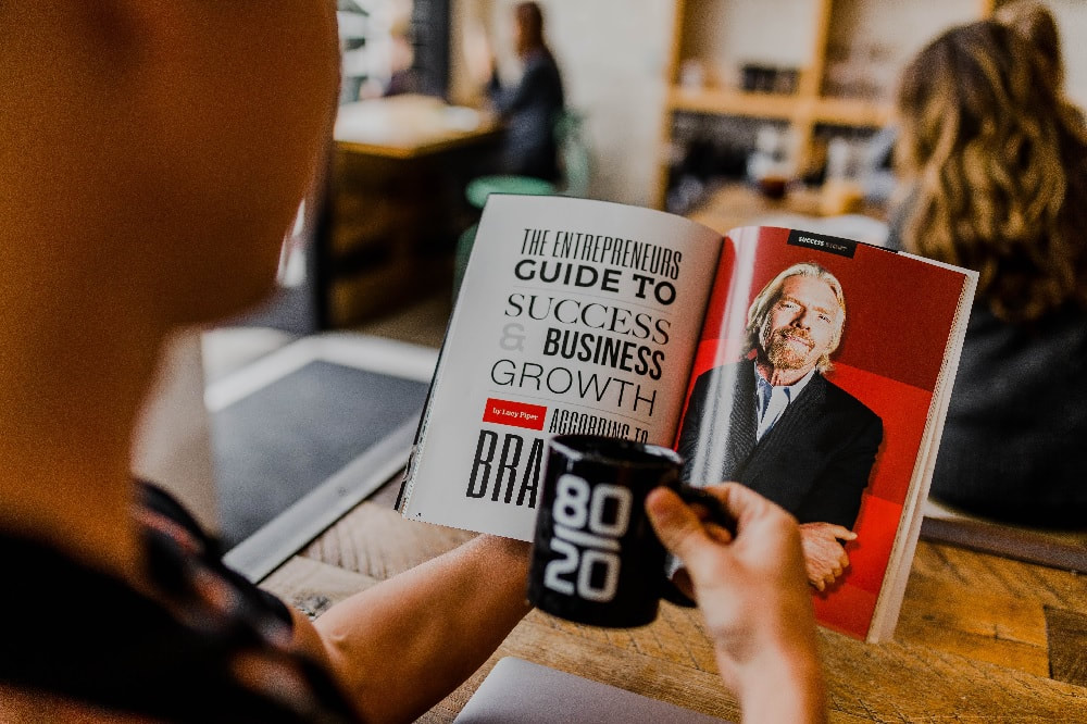 person reading a book for entrepreneurs