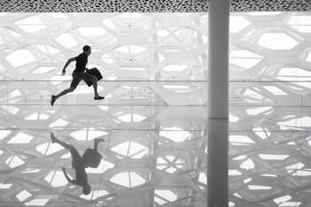man running across a glass floor
