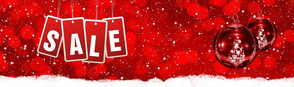 Image of a christmassy red background with the words sale to the left and red baubles to the right