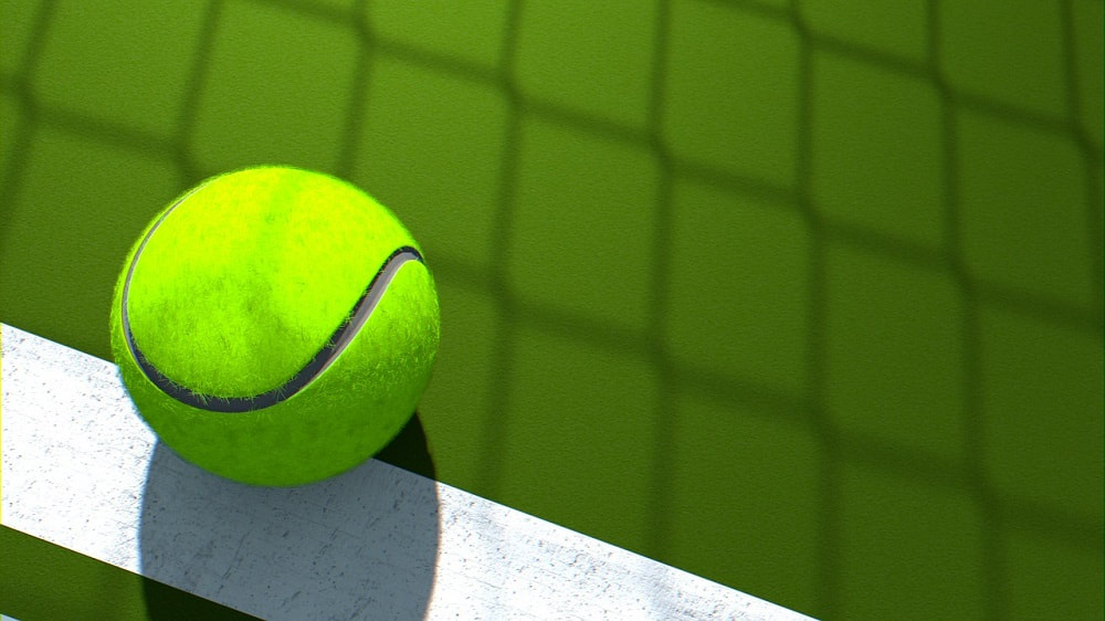 green tennis ball on a white line